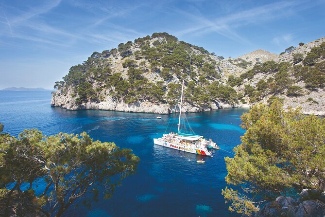 Mallorca Catamaran Cruise with Scenic Views and BBQ Lunch - Stop 4 at Aucanada Beach and the lighthouse photo moment